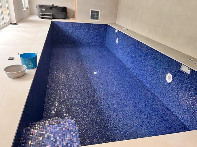 Blue mosaic pool shell with mosaic bench