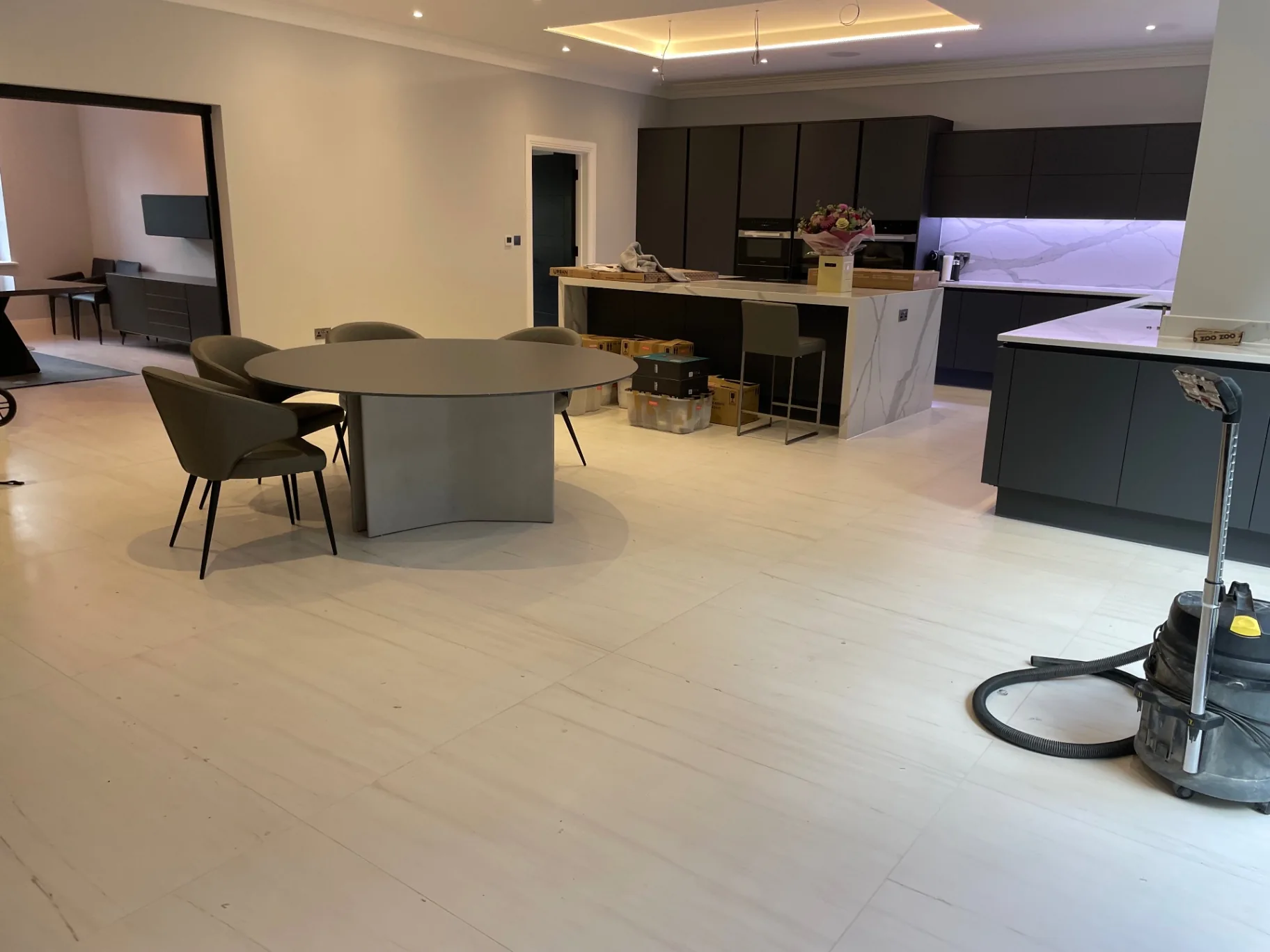 Polished marble-effect porcelain through the open-plan kitchen and dining room