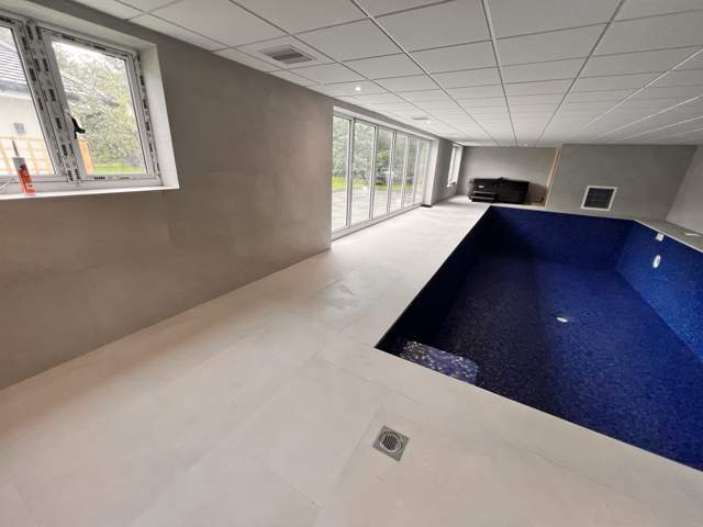 Finished indoor pool hall with porcelain surround